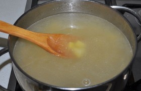 Вынимаем кусок копчености, чтобы немного остыл, а в бульон закладываем нарезанный картофель и промытый рис, бросаем перец. После закипания они варятся (опять же под крышкой) 20-25 минут.