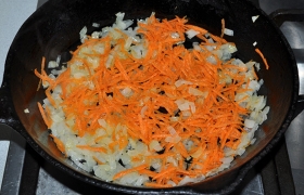 Через 5 минут добавляем натертую морковь и обжариваем еще 3-4 минуты.