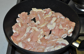 Полоски филе выкладываем в раскаленную сковороду с парой ложек масла. 
