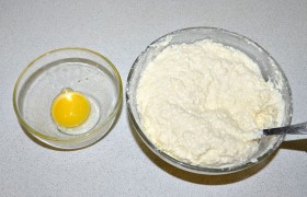 Одно яйцо целиком и белок второго (желток пойдет на смазку сочней) добавляем к творогу, еще – сахар и сметану. Хорошо вымешиваем. Если начинка жидковата – подсыпаем немного муки. 
