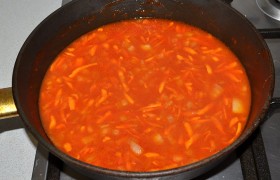 Добавляем томатную пасту, кетчуп, сахар и немного соли и перца, помешиваем минуту-две, вливаем горячую воду. Тушим соус 3-4 минуты.