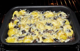 И снова ставим в духовку на 10-12 минут. После чего вынимаем форму с запеченными картофелем и грибами под корочкой расплавленного сыра - и делим на порции.
