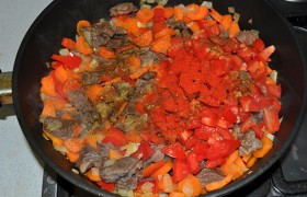 Спустя 6-7 минут добавляем нарезанные кубиком помидоры, паприку, соль и перец, даем закипеть.