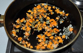 Ставим на средний огонь тяжелую просторную сковороду, наливаем масло – для разогрева. Мелко шинкуем луковицу и морковь,  пассеруем  вместе 8-10 минут, пока лук станет совсем прозрачным, а морковь – почти мягкой. 