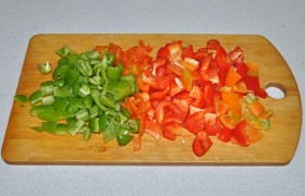Одновременно в отдельной сковороде подготавливаем соус. Небольшими кусочками нарезаем сладкий перец, лучше разных цветов.