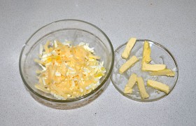 Натираем для начинки яйца и сыр, чуть солим, перемешиваем. Подмороженное сливочное масло делим на тонкие брусочки.