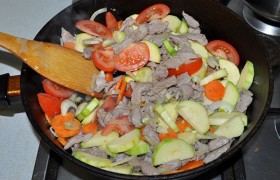 Заранее нарезаем овощи: лук и кабачок – четвертинками кружков, морковь – кружками, помидоры – дольками, сладкий перец – по желанию. Теперь кладем их в сковороду, жарим, перемешивая, минут 10-15, снизив огонь до средне-сильного.