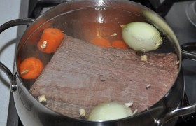 Закладываем в кастрюлю с кипящей водой, прикрывающей мясо. После закипания кладем лук, морковь, перец, коренья, лавровый лист, убавляем огонь - и пусть себе 1,5-2,5 часа  варится  до готовности, под крышкой и на очень малом огне. Солим незадолго до окончания варки. 
