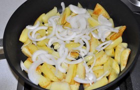 За те 8-9 минут, что жарится картофель (мы его переворачиваем периодически), очищаем и шинкуем половинками колец лук, а также снимаем филе рыбы с кожи и нарезаем кубиками. Солим и хорошо обрызгиваем лимонным соком, перемешиваем. Добавив к картошке лук, 